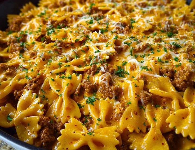 Cajun Cream Cheese Alfredo Bowties topped with spiced ground beef