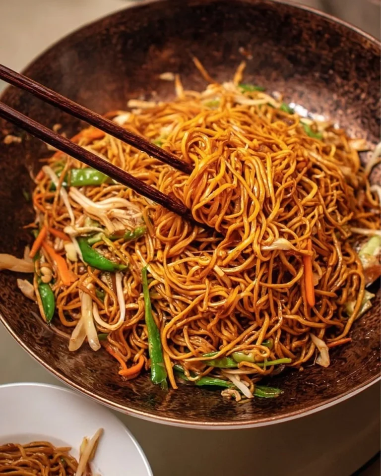 Delicious plate of classic Chinese fried noodles garnished with vegetables