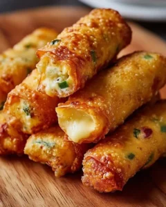 Mini jalapeño popper egg rolls served on a plate with dipping sauce