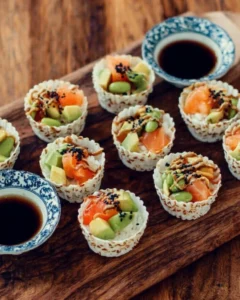 Colorful sushi cups filled with fresh ingredients and garnished for presentation.
